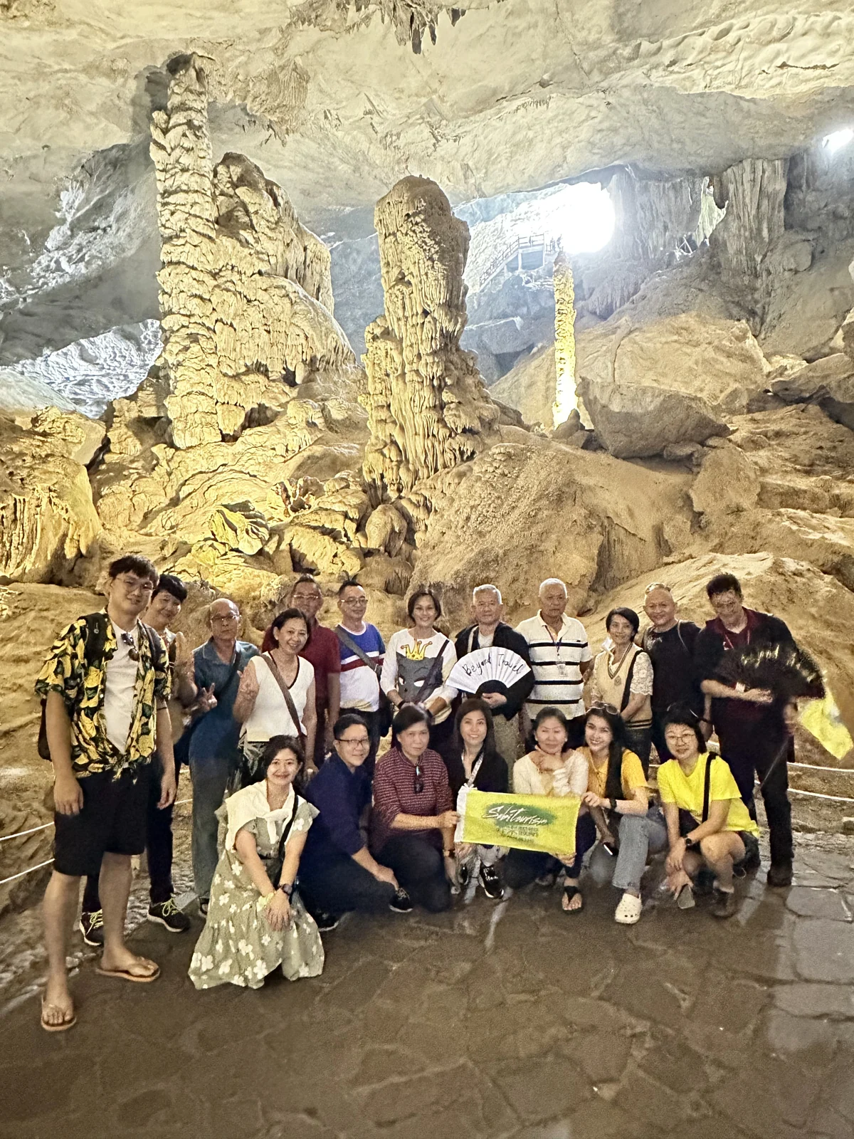 Travellers with the tour flag inside a cave