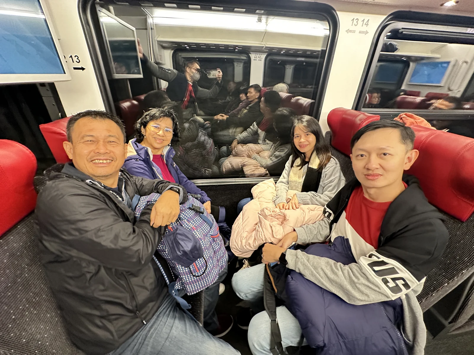 Travellers enjoying a train journey in Switzerland