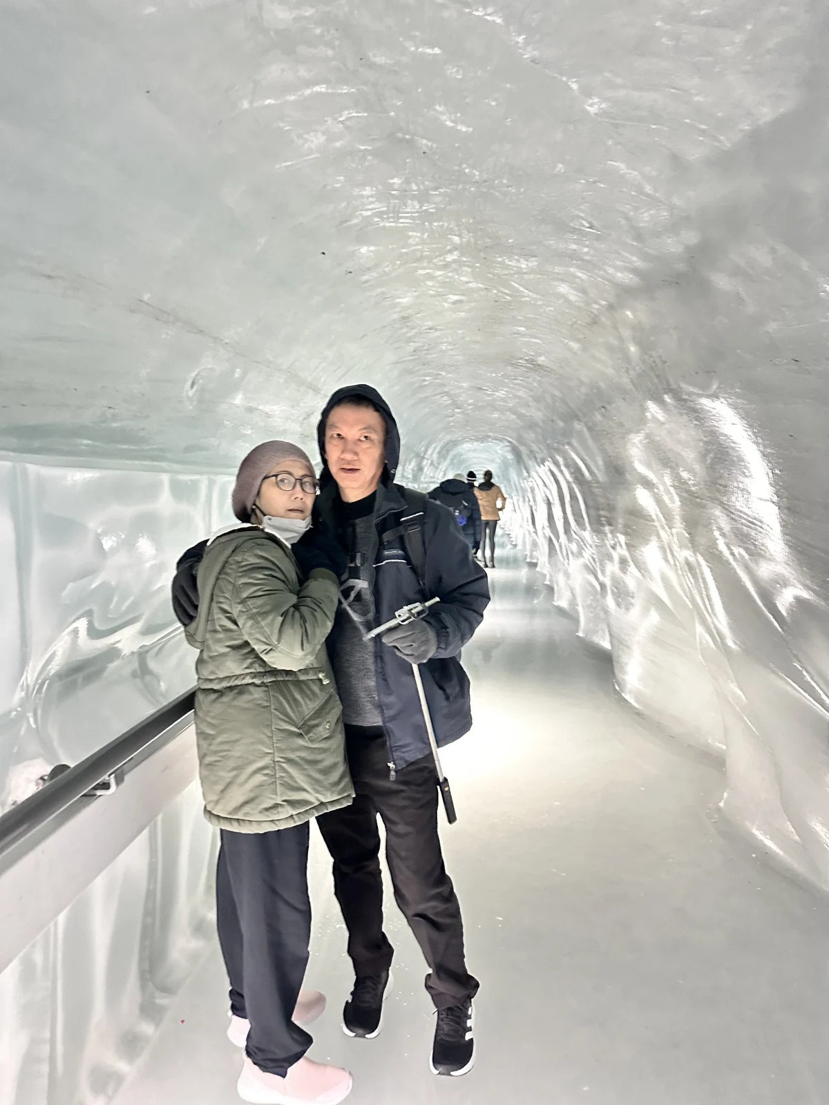 Travellers visiting an ice palace in Switzerland