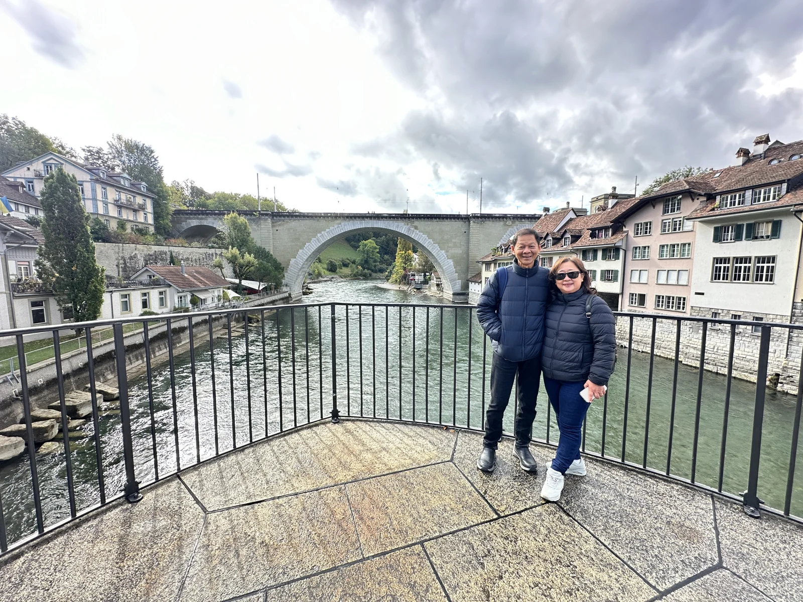Travellers walking by the river in a Swiss old town