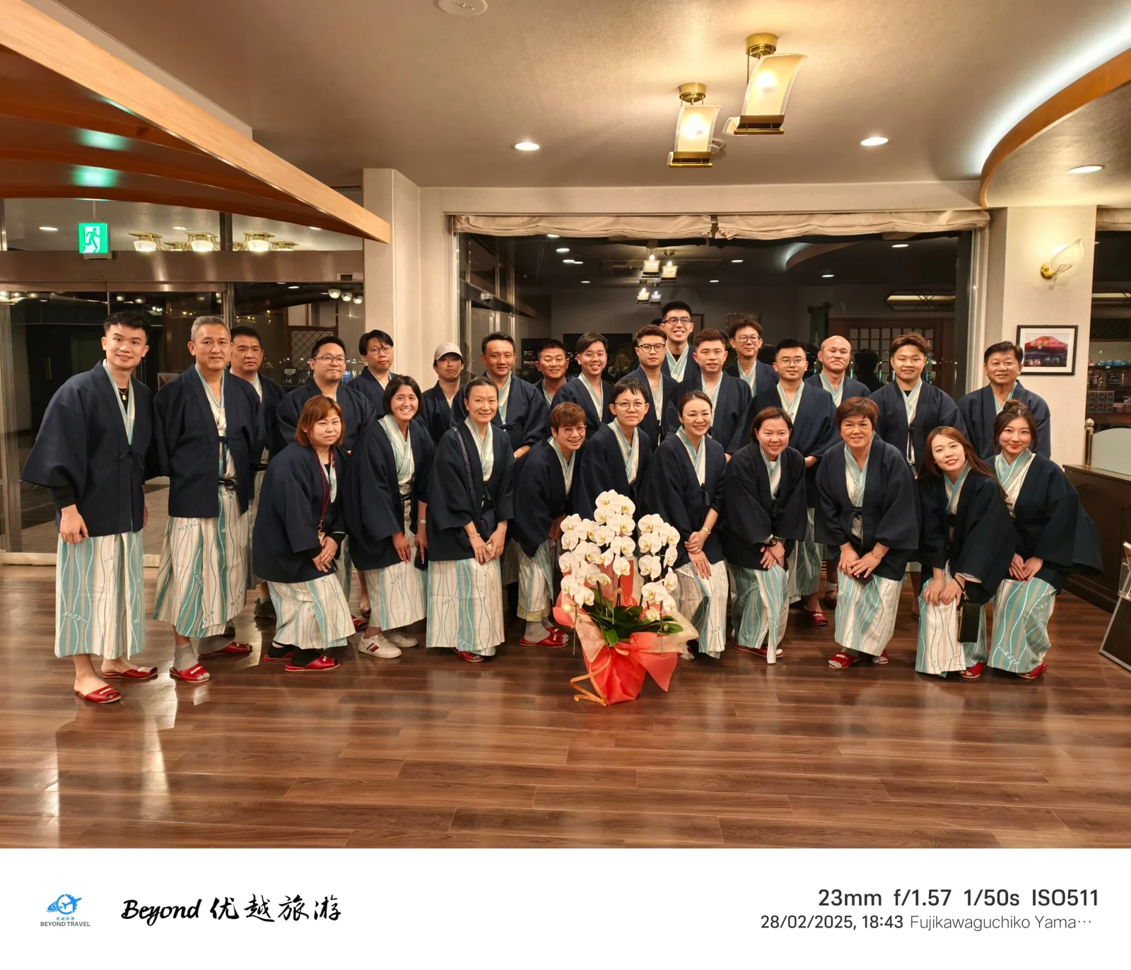 Our travel group posing indoors in traditional costumes