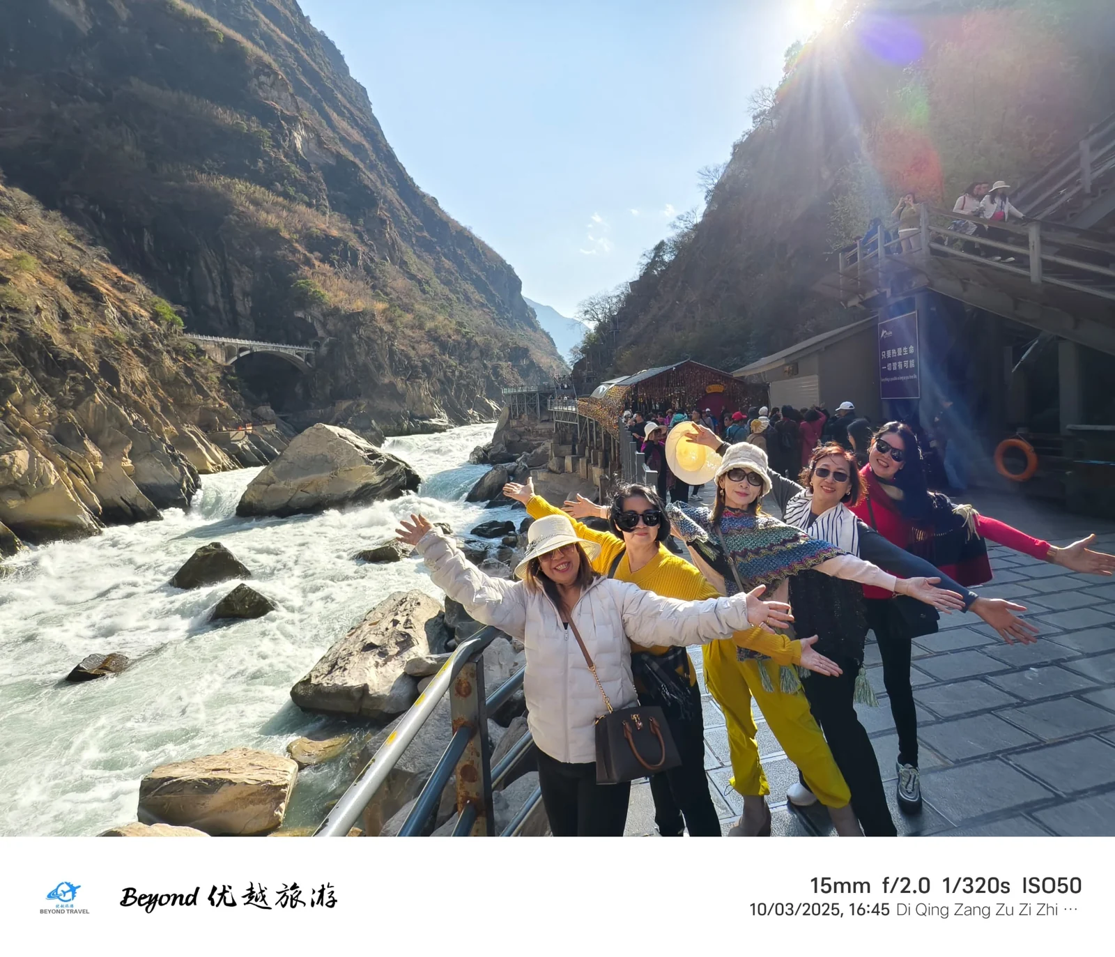 Travellers posing by a river in a gorge