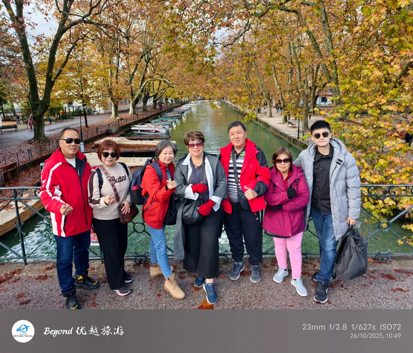 Travellers beside a canal in autumn