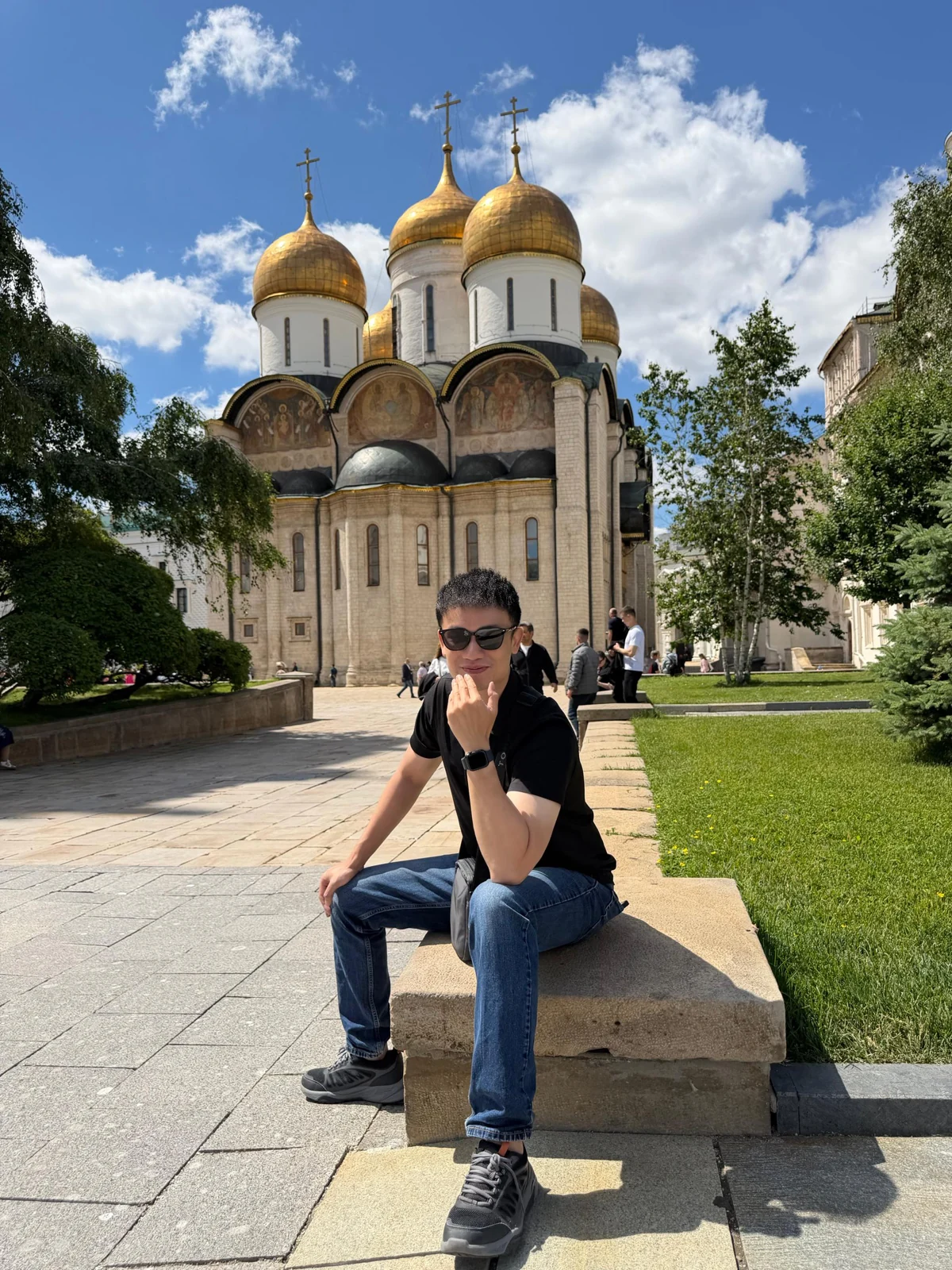 Travellers posing in front of a golden-domed church in Russia