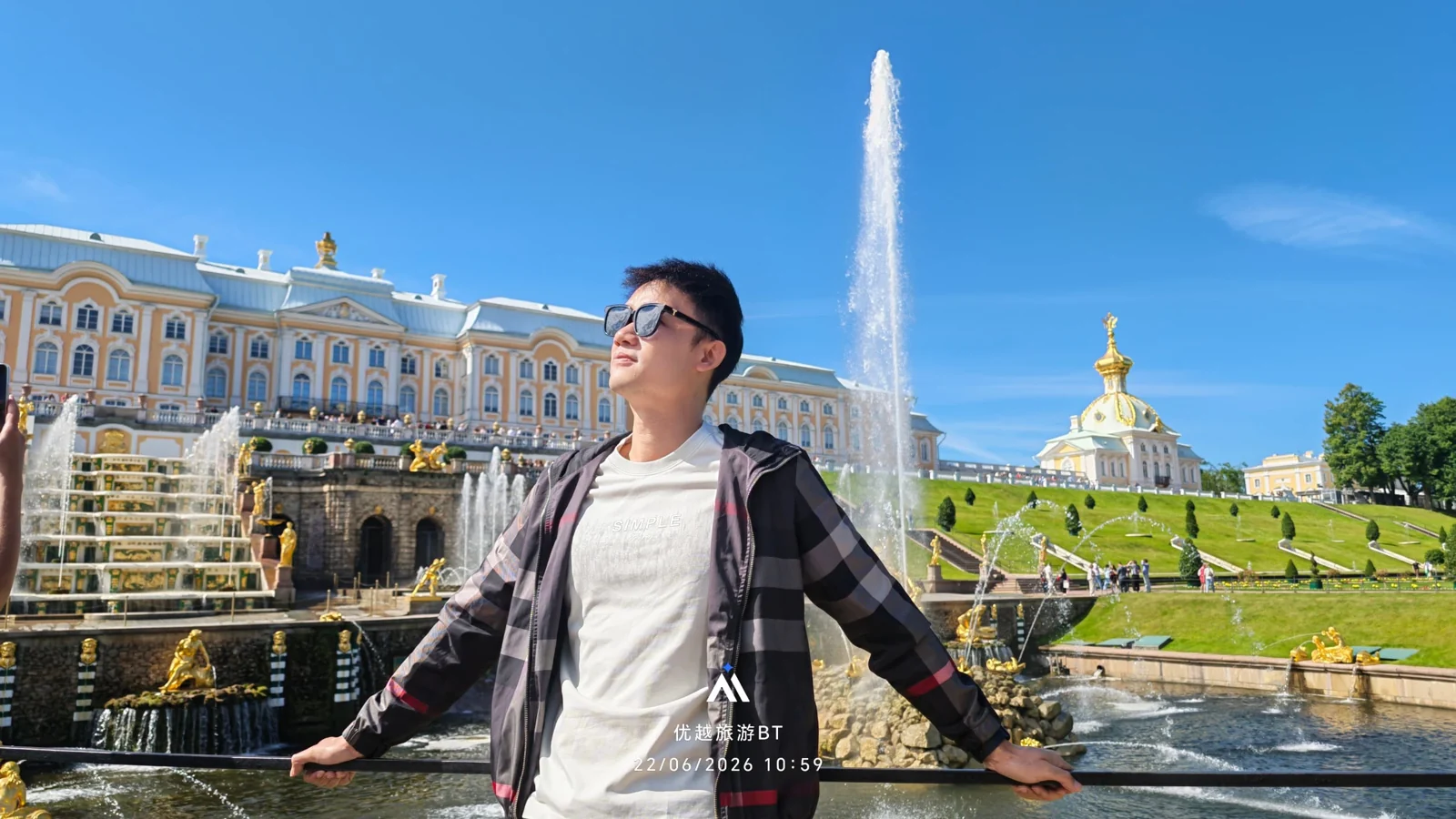 Travellers posing by palace fountains in Russia