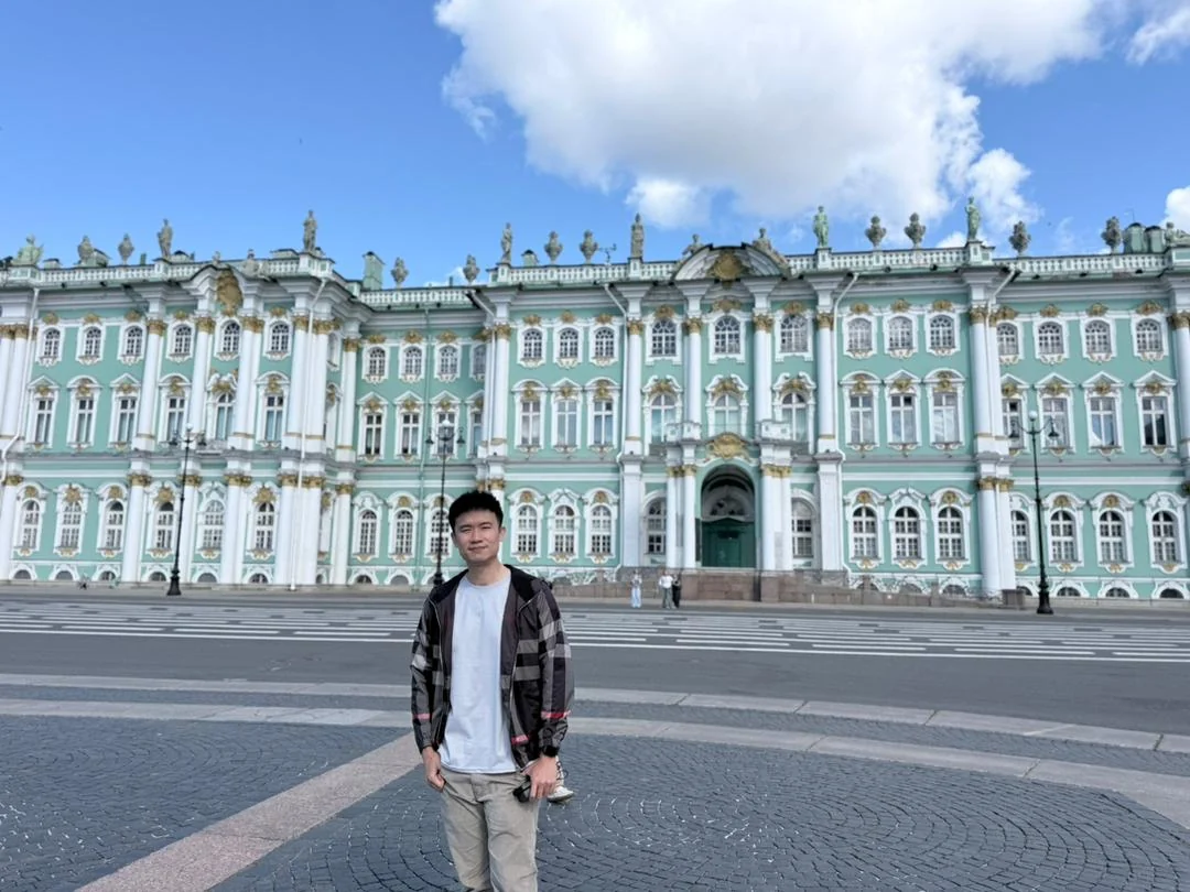 Travellers posing in Palace Square in Russia